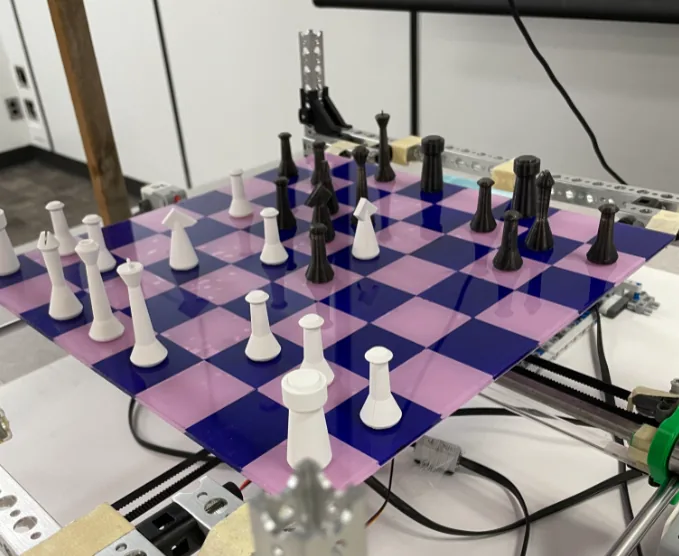 Physical autonomous Chess Bot beside its chess board